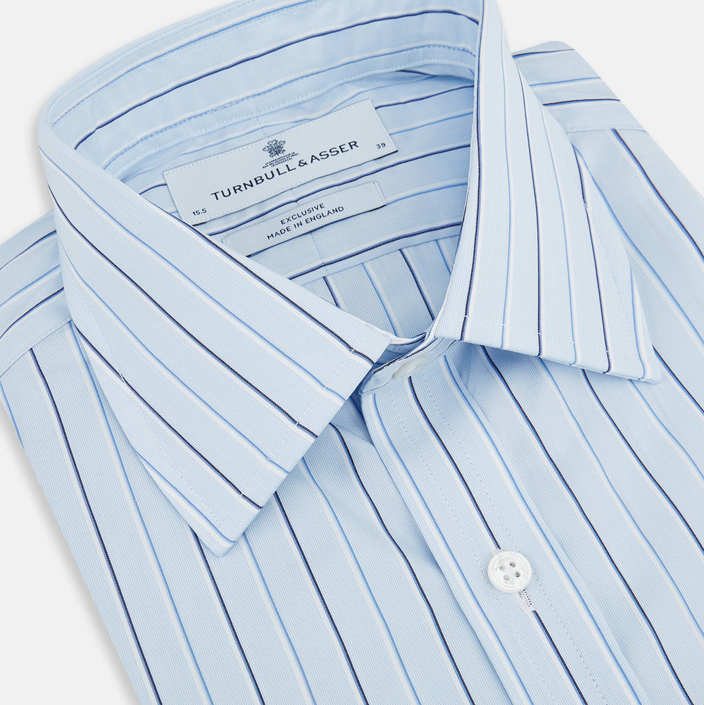 The Turnbull & Asser Navy and Blue Combination Stripe Mayfair Shirt, featuring thin vertical stripes and a classic collar, is displayed laid flat on a white background.