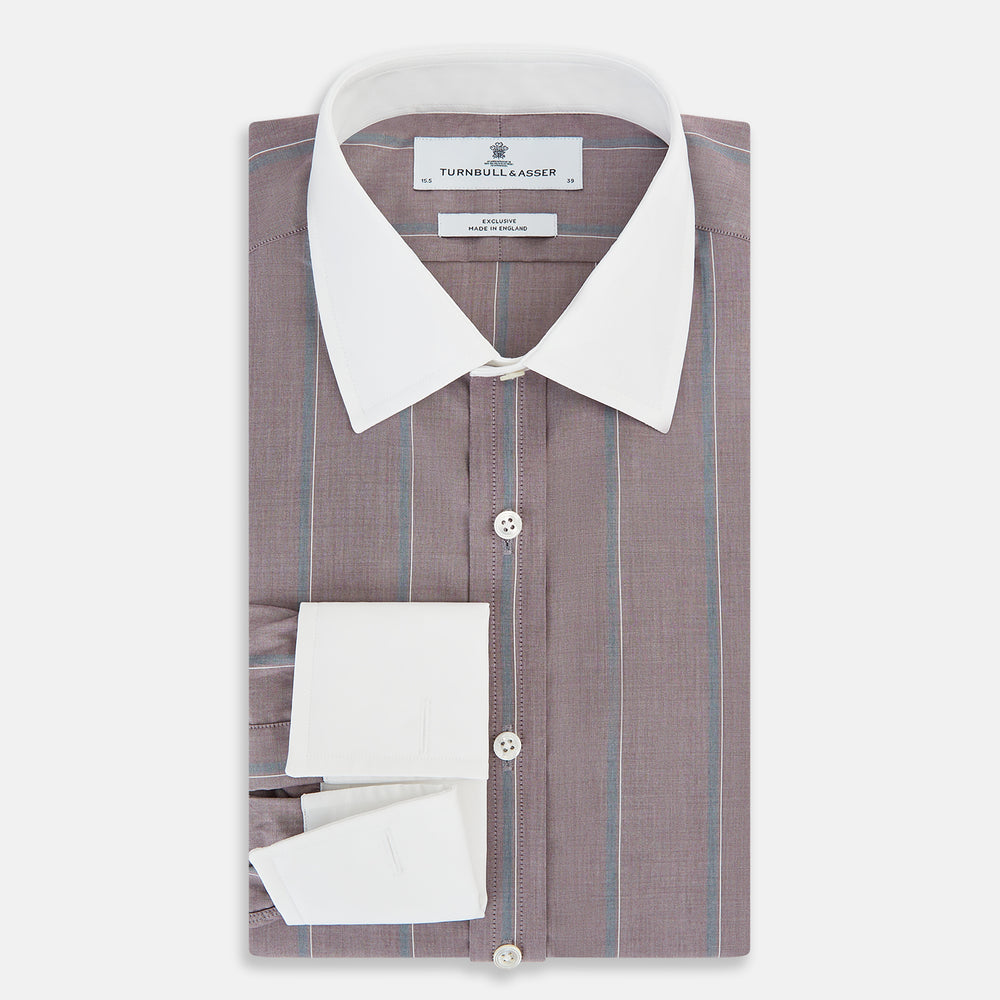 The Turnbull & Asser Light Porto Red Track Stripe Shirt features a Mayfair fit and contrast white T&A collar and cuffs, with vertical blue stripes on mauve, exemplifying British craftsmanship.