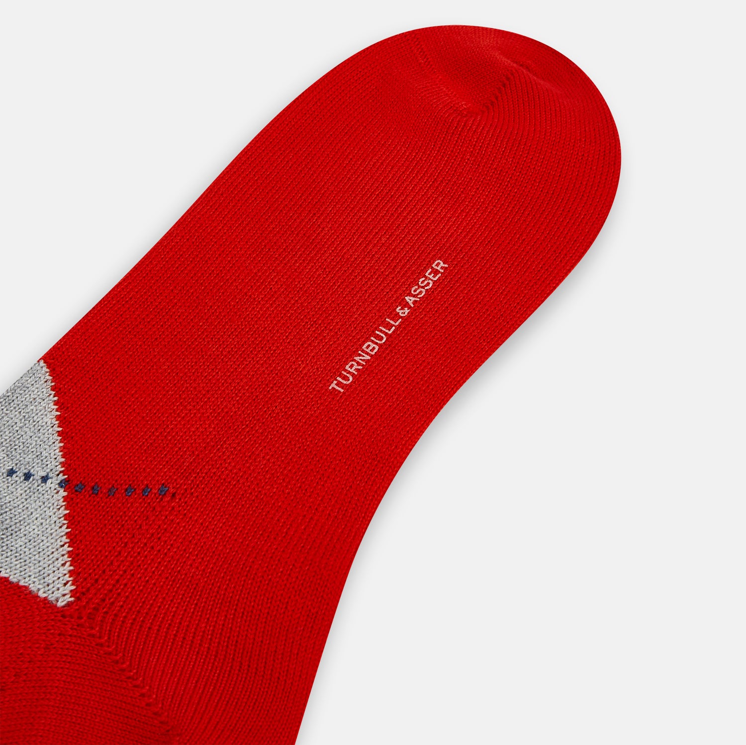 View 3 of product Mid-length orange wool socks by Turnbull & Asser, featuring a classic check pattern in orange, beige, and gray, reminiscent of timeless wool socks, displayed on a plain light background.