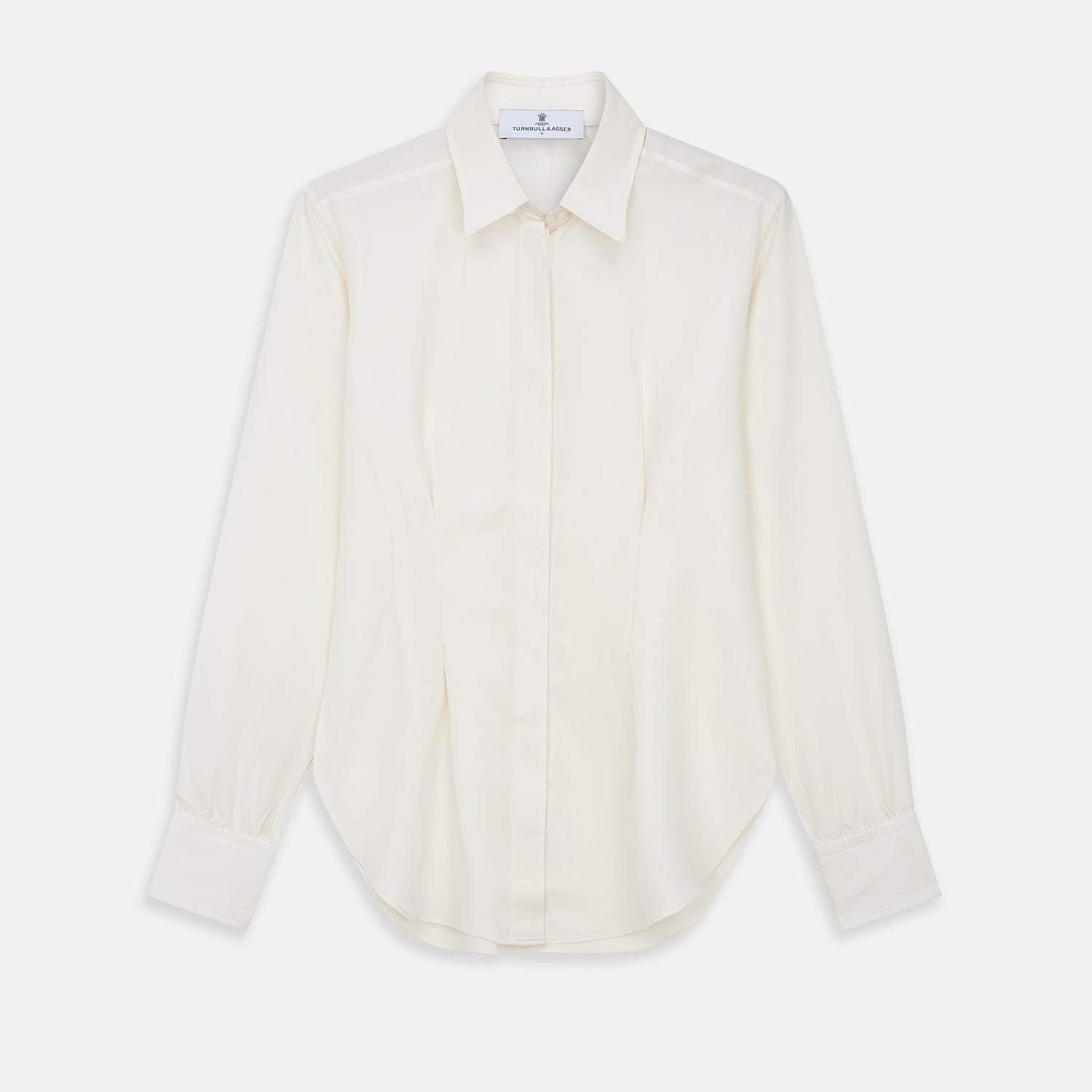 View 1 of product The Cream Silk Tailored Bianca Shirt by Turnbull & Asser features long sleeves, a pointed collar, and curved hem in soft-touch peace silk with a tailored fit. Shown laid flat on a white background.
