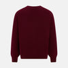 View 3 of product The Turnbull & Asser Burgundy Cashmere Cardigan features a V-neck, ribbed cuffs and hem, two front pockets, and a classic button-up design, shown on a plain white background.