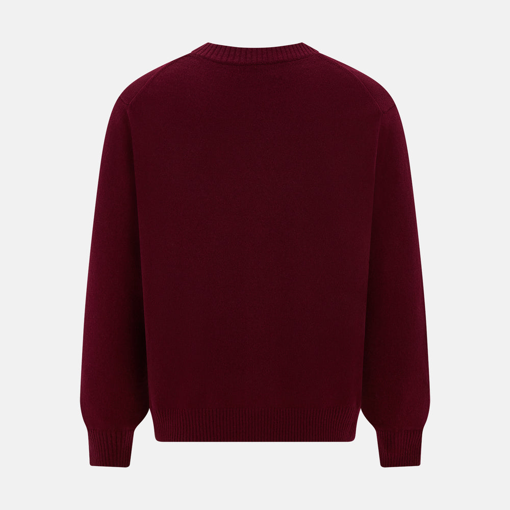 The Turnbull & Asser Burgundy Cashmere Cardigan features a V-neck, ribbed cuffs and hem, two front pockets, and a classic button-up design, shown on a plain white background.