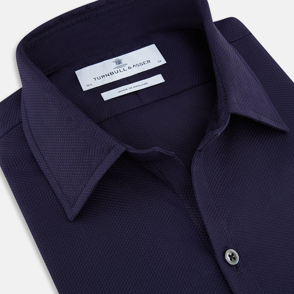 The Navy Textured Windsor Shirt by Turnbull & Asser features long sleeves, a Windsor collar, buttoned cuffs, and white buttons—a fine example of British craftsmanship—set against a plain white background.