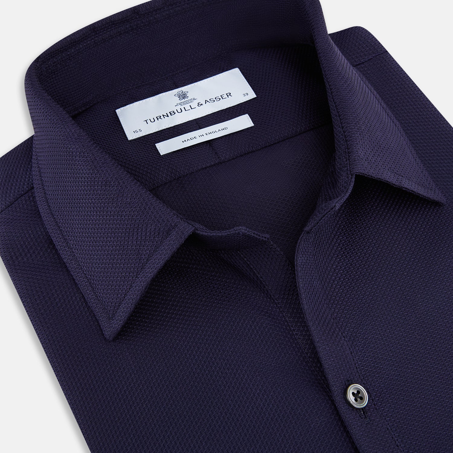 View 2 of product The Navy Textured Windsor Shirt by Turnbull & Asser features long sleeves, a Windsor collar, buttoned cuffs, and white buttons—a fine example of British craftsmanship—set against a plain white background.