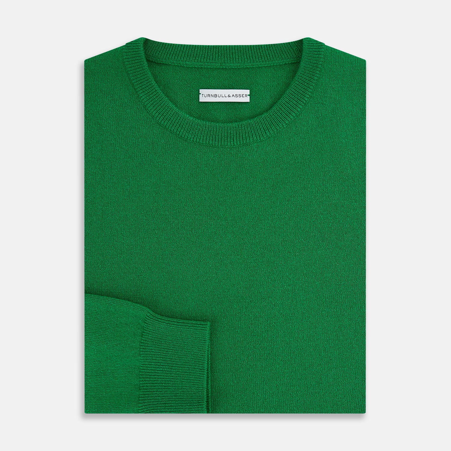 View 4 of product The Turnbull & Asser Grass Green Cashmere Round Neck Jumper features long sleeves, ribbed cuffs, collar, and hem, shown on a white background.