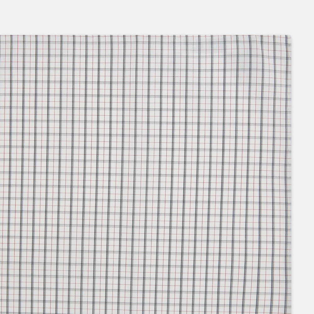 The Red Multi Graph Check Hand-Rolled Handkerchief by Turnbull & Asser features thin black, red, and blue lines forming small squares on white fabric, finished with delicate hand-rolled edges.