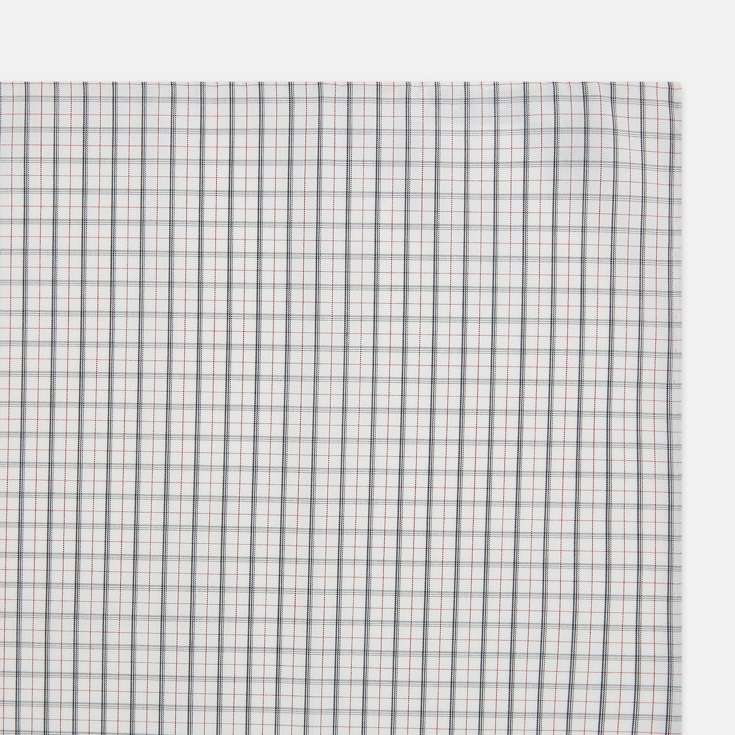 View 2 of product The Red Multi Graph Check Hand-Rolled Handkerchief by Turnbull & Asser features thin black, red, and blue lines forming small squares on white fabric, finished with delicate hand-rolled edges.