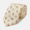 View 1 of product The Yellow Geometric Rings Silk Tie by Turnbull & Asser features a cream silk base with yellow geometric patterns and maroon rings, is hand-finished in England, and is shown rolled up on a white background.
