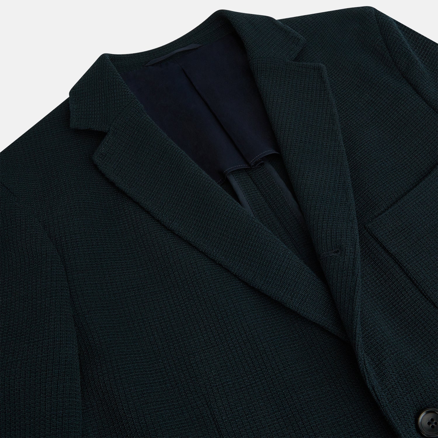 View 2 of product The Forest Green KNITTED CAMBRIDGE BLAZER by Turnbull & Asser, crafted from textured Italian wool with notch lapels, patch and chest pockets, and two buttons, is shown against a plain white background.