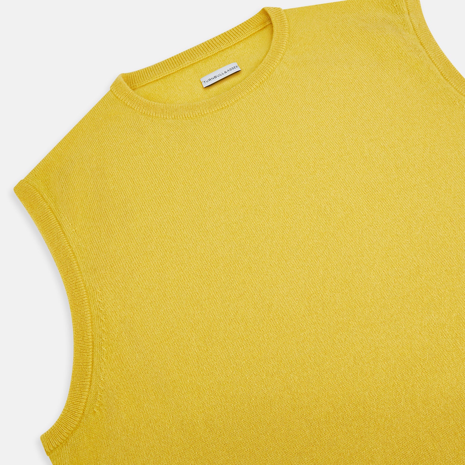 View 2 of product The Turnbull & Asser Canary Yellow Cashmere Round Neck Vest is a sleeveless jumper featuring ribbed collar, hem, and armholes, shown against a plain white background.