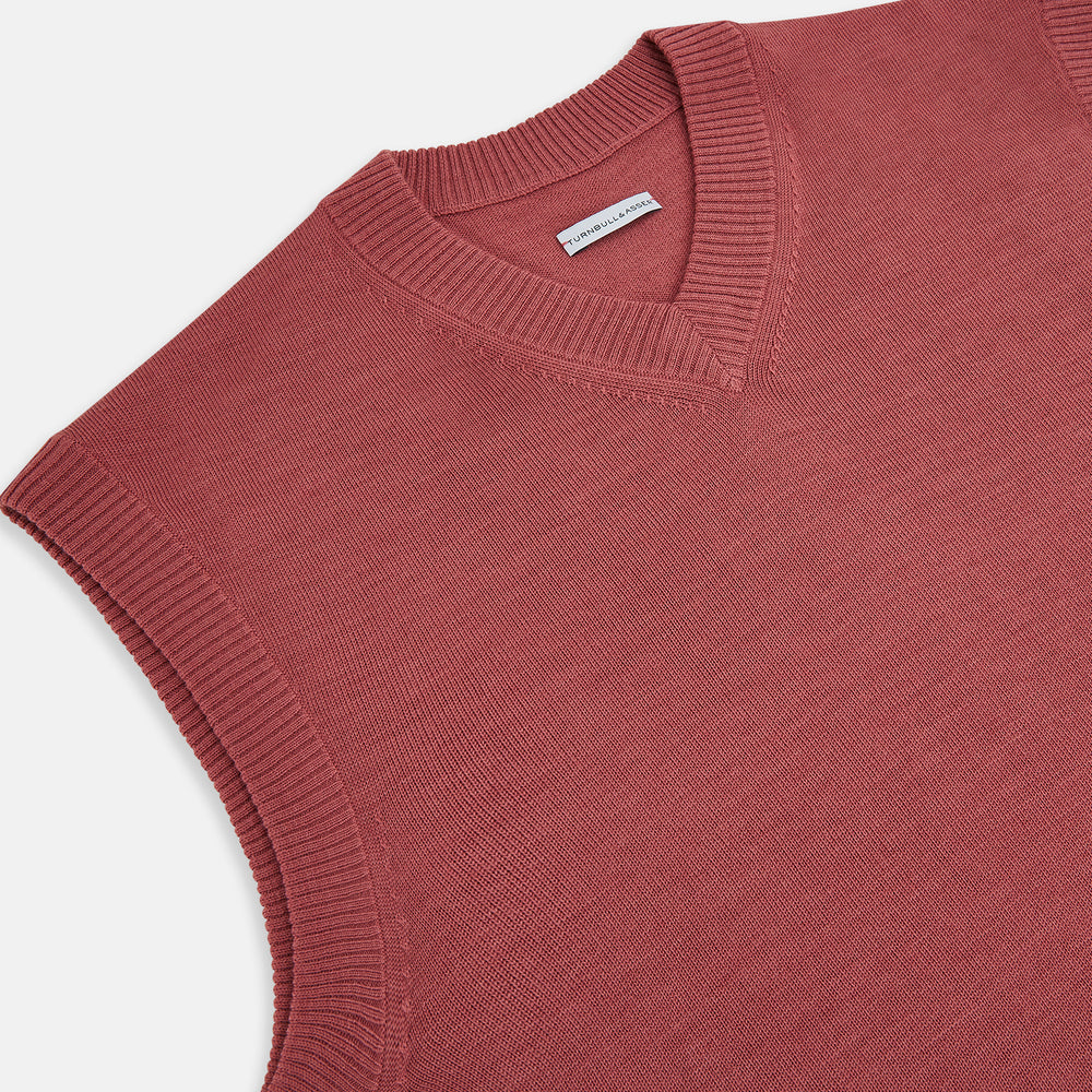 The Turnbull & Asser Antique Pink Fine Merino V-Neck Vest features ribbed trim at the neckline, armholes, and hem—a stylish layering piece for cooler seasons. Shown against a plain white background.