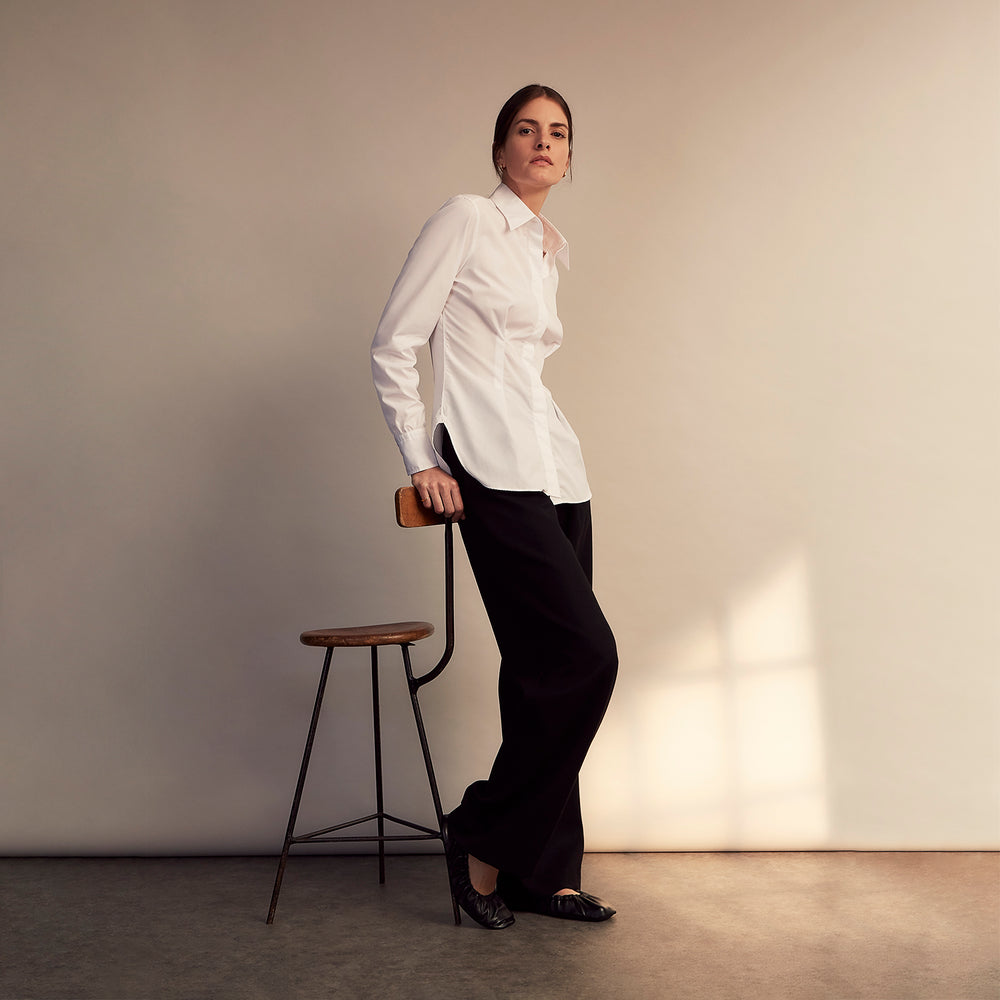 The White Cotton Tailored Bianca Shirt by Turnbull & Asser features a pointed collar and button cuffs, crafted from soft organic cotton and displayed flat on a white background for timeless elegance.