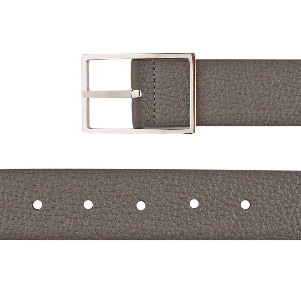The Turnbull & Asser Nubuk Reversible Leather Belt is shown coiled on a plain white background, featuring gray textured leather and a rectangular silver buckle.