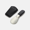 View 3 of product The Turnbull & Asser Forest Green Travel Shoe Horn features a wide, smooth metal blade and a forest green leather handle, shown against a plain white background.
