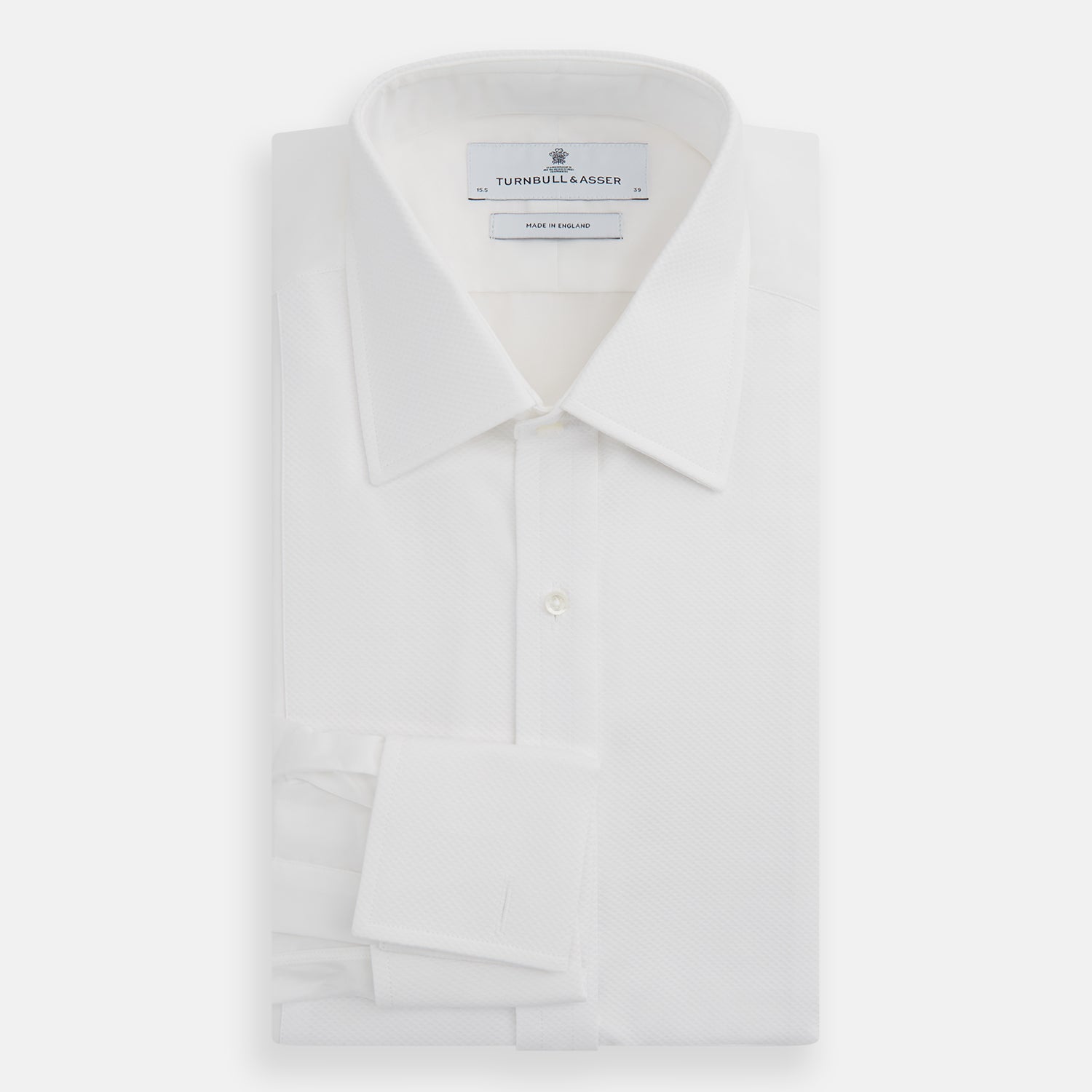 View 5 of product The Turnbull & Asser White Marcella Dress Shirt features a T&A collar, double cuffs, and pleated front detailing—ideal for formal occasions. Displayed on a plain white background.