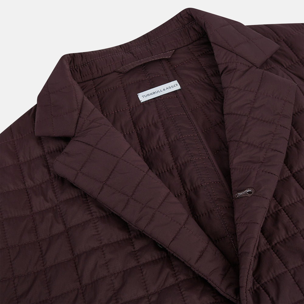 The Fulham Burgundy Single-Breasted Quilted Blazer by Turnbull & Asser features a grid pattern, notch lapel, three buttons, and three front pockets. Shown on a plain white background—ideal for the modern gentleman.