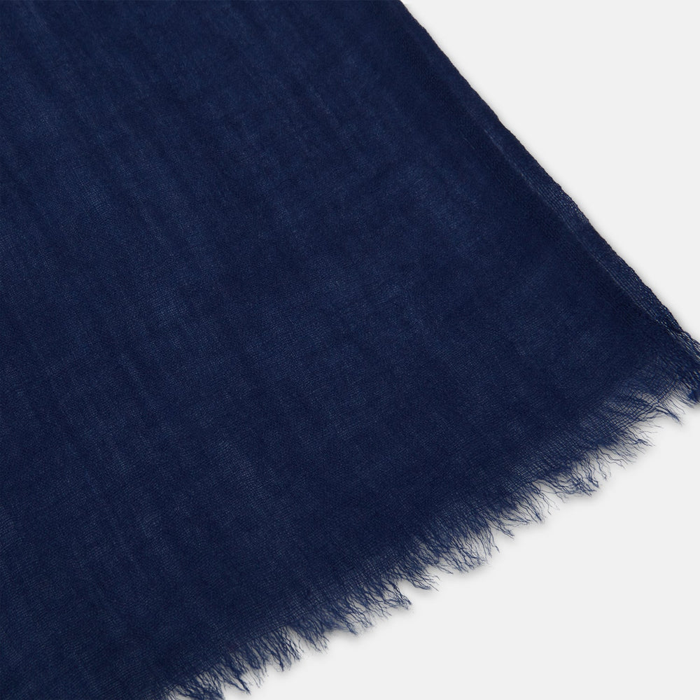 The Turnbull & Asser Navy Cashmere Scarf features a subtle texture and frayed edges, loosely knotted at the top and displayed against a plain white background.