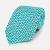 View 1 of product The Turnbull & Asser Turquoise Flower Patterned Printed Silk Tie, crafted from fine English silk, is neatly rolled on a white background.