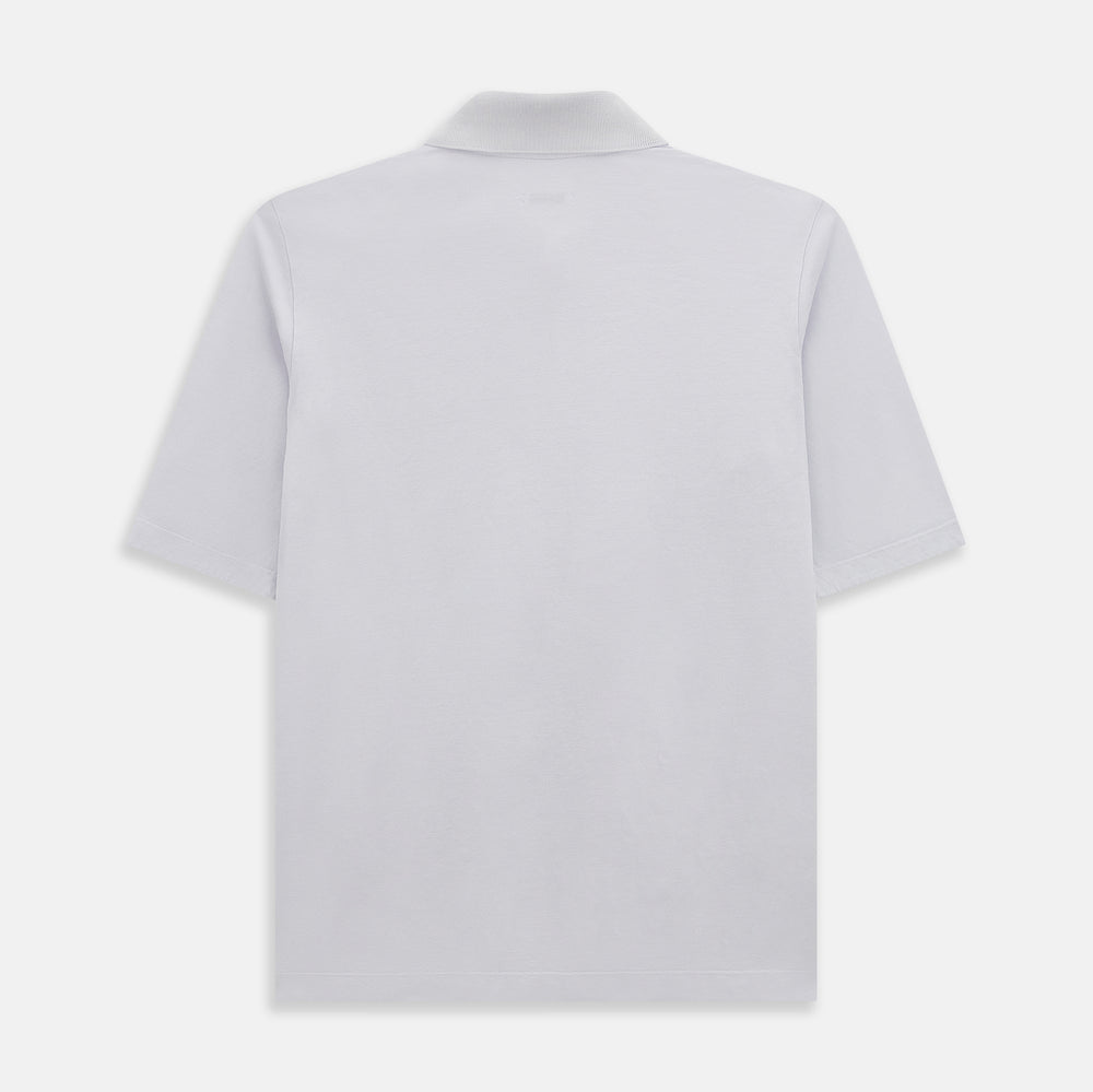 A soft pink cotton polo shirt by Turnbull & Asser features short sleeves, a contrasting white collar, three dark buttons, and a left chest pocket. Laid flat on a white background—it’s perfect for modern men’s fashion.