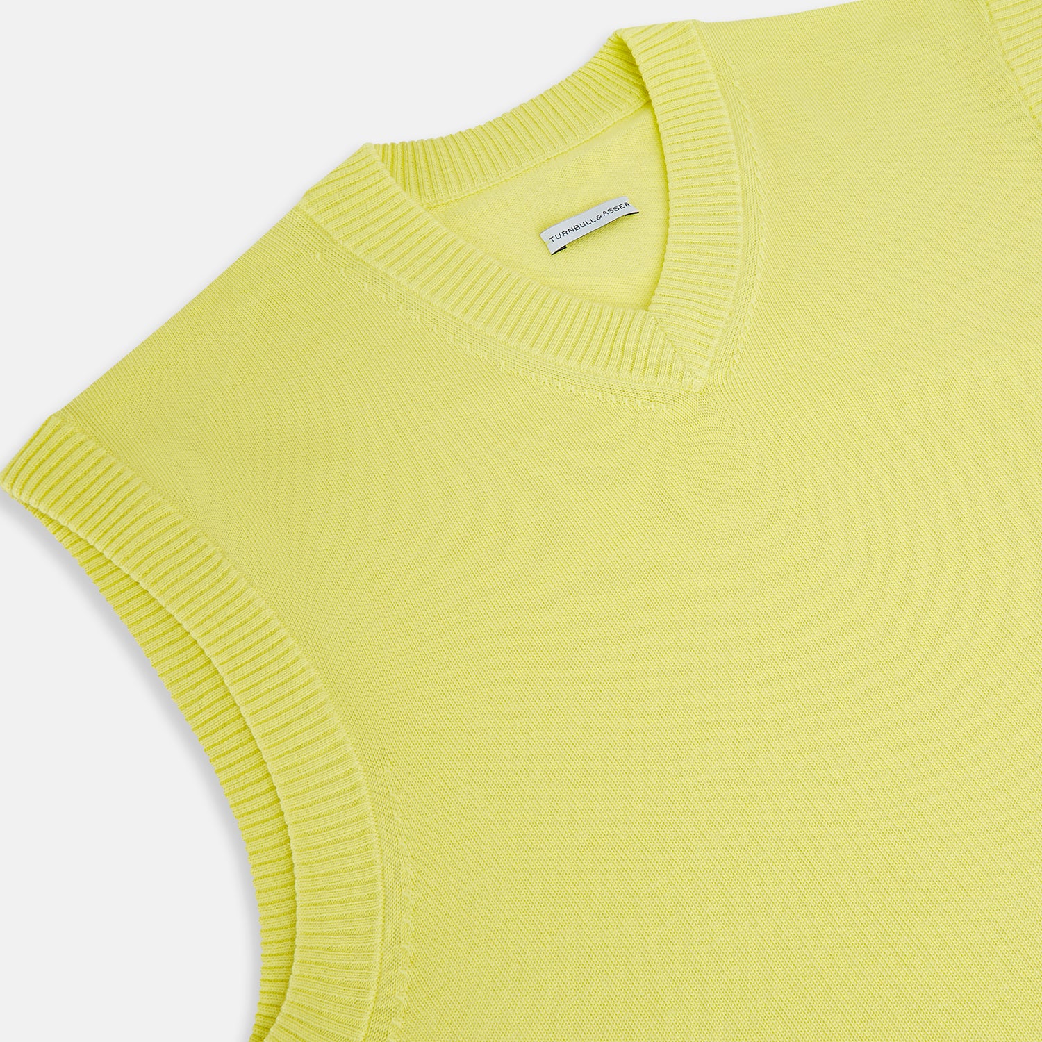 View 2 of product The Bright Yellow Fine Merino V-Neck Vest by Turnbull & Asser is a sleeveless jumper with ribbed edges, shown on a white background—ideal for the refined gentleman who values classic style.