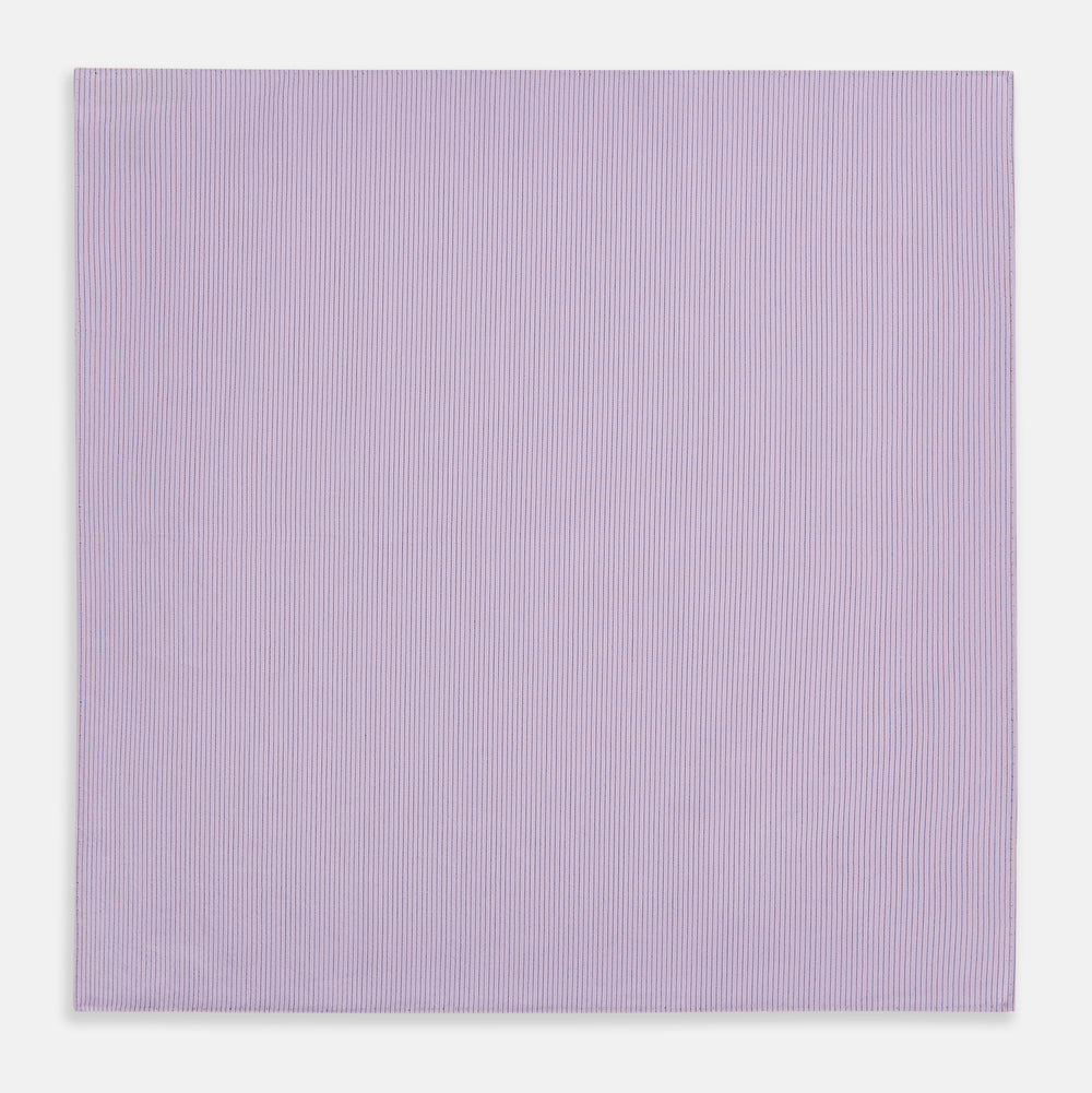 The Turnbull & Asser Lilac Pinstripe Hand-Rolled Handkerchief is a neatly folded, square, lavender piece with a subtle ribbed texture and hand-rolled edges, displayed flat on a white background.