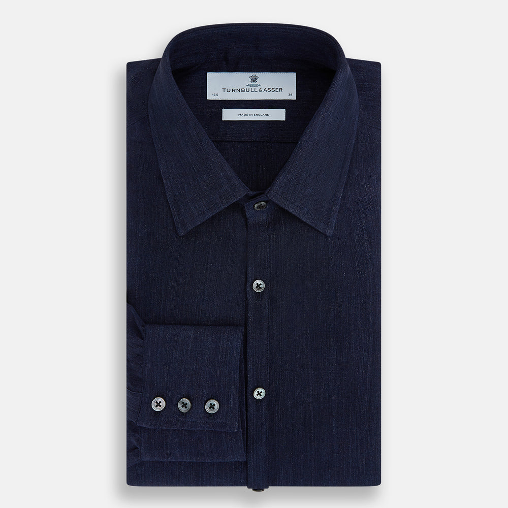 The Navy Linen Westminster Shirt by Turnbull & Asser features a classic collar and buttoned cuffs, exemplifying British craftsmanship. Shown here in long sleeves, the shirt is displayed flat against a white background.