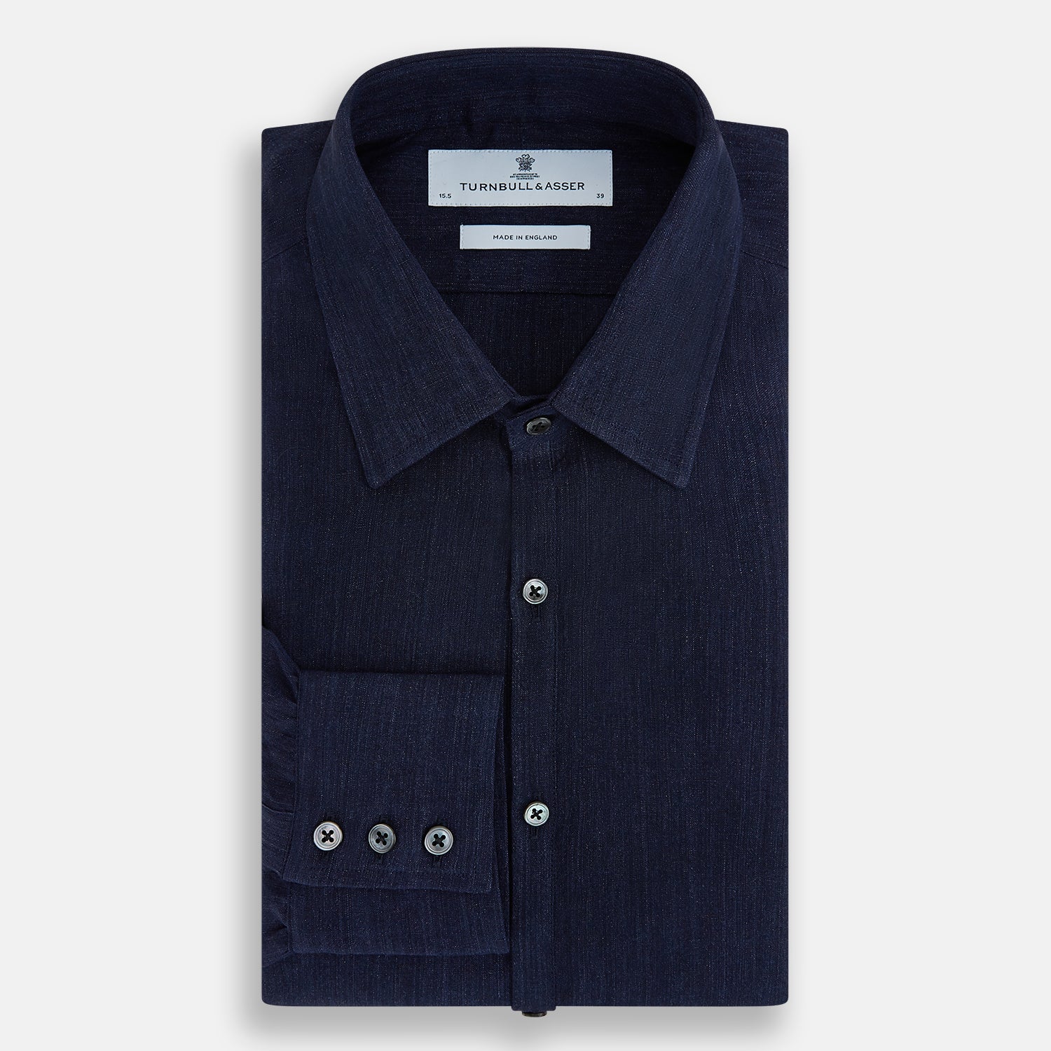 View 5 of product The Navy Linen Westminster Shirt by Turnbull & Asser features a classic collar and buttoned cuffs, exemplifying British craftsmanship. Shown here in long sleeves, the shirt is displayed flat against a white background.