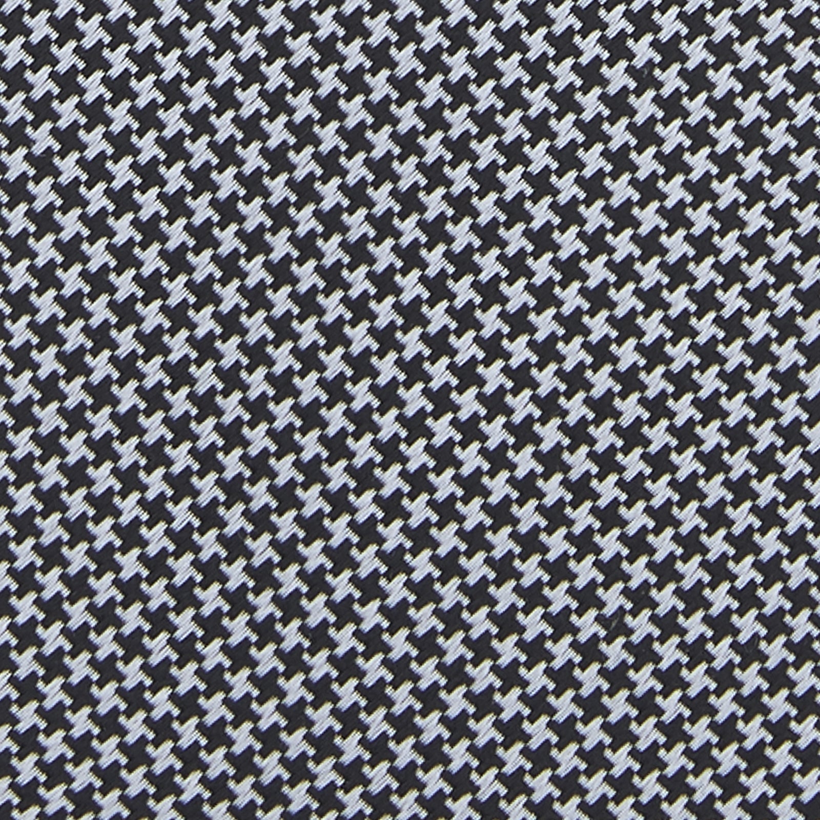 View 3 of product The Turnbull & Asser White and Black Houndstooth Woven Silk Tie, shown rolled on a light grey background, adds a classic touch to any smart outfit.