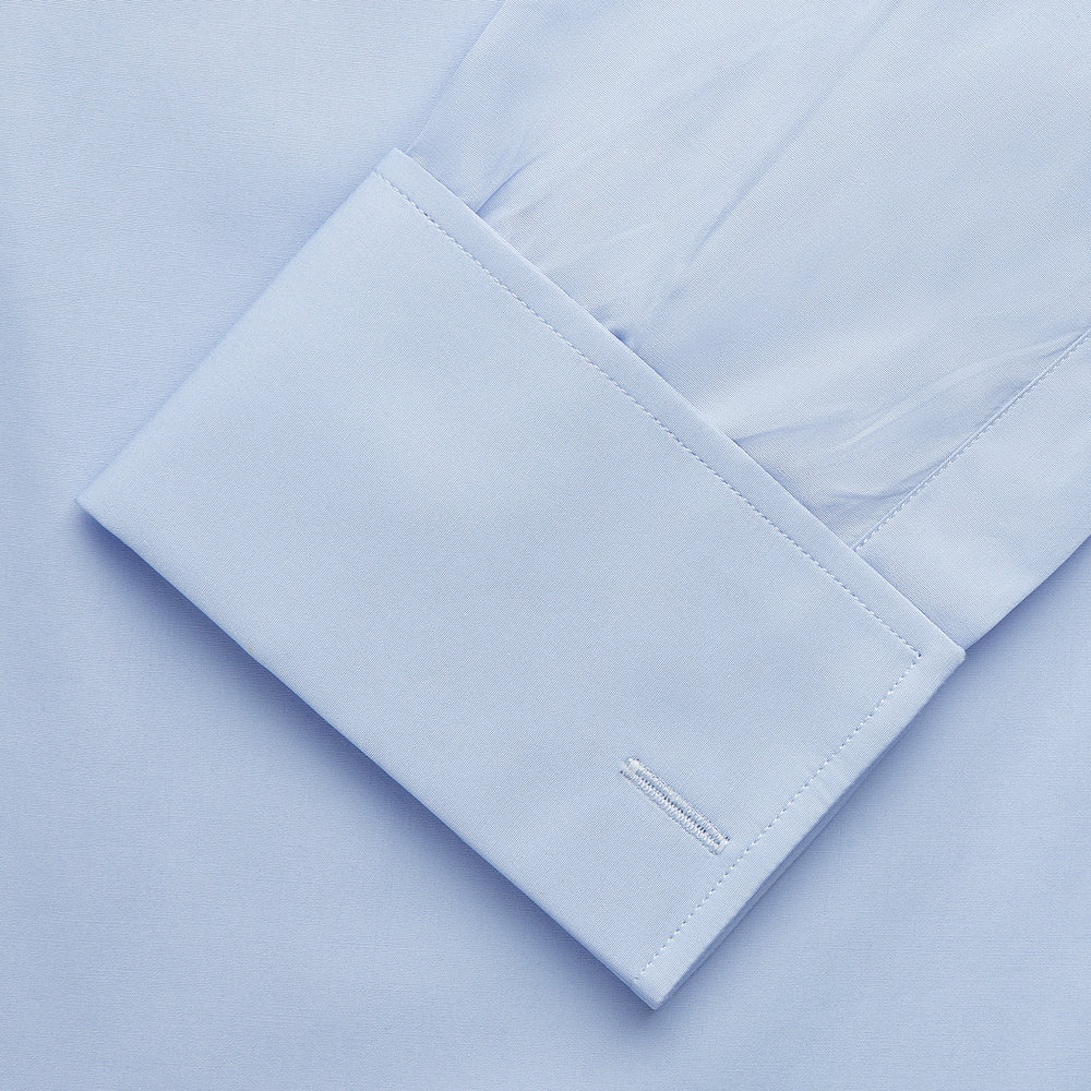 The Turnbull & Asser Tailored Fit Pale Blue Cotton Shirt features a Kent collar and double cuffs—ideal for pairing with a navy suit.