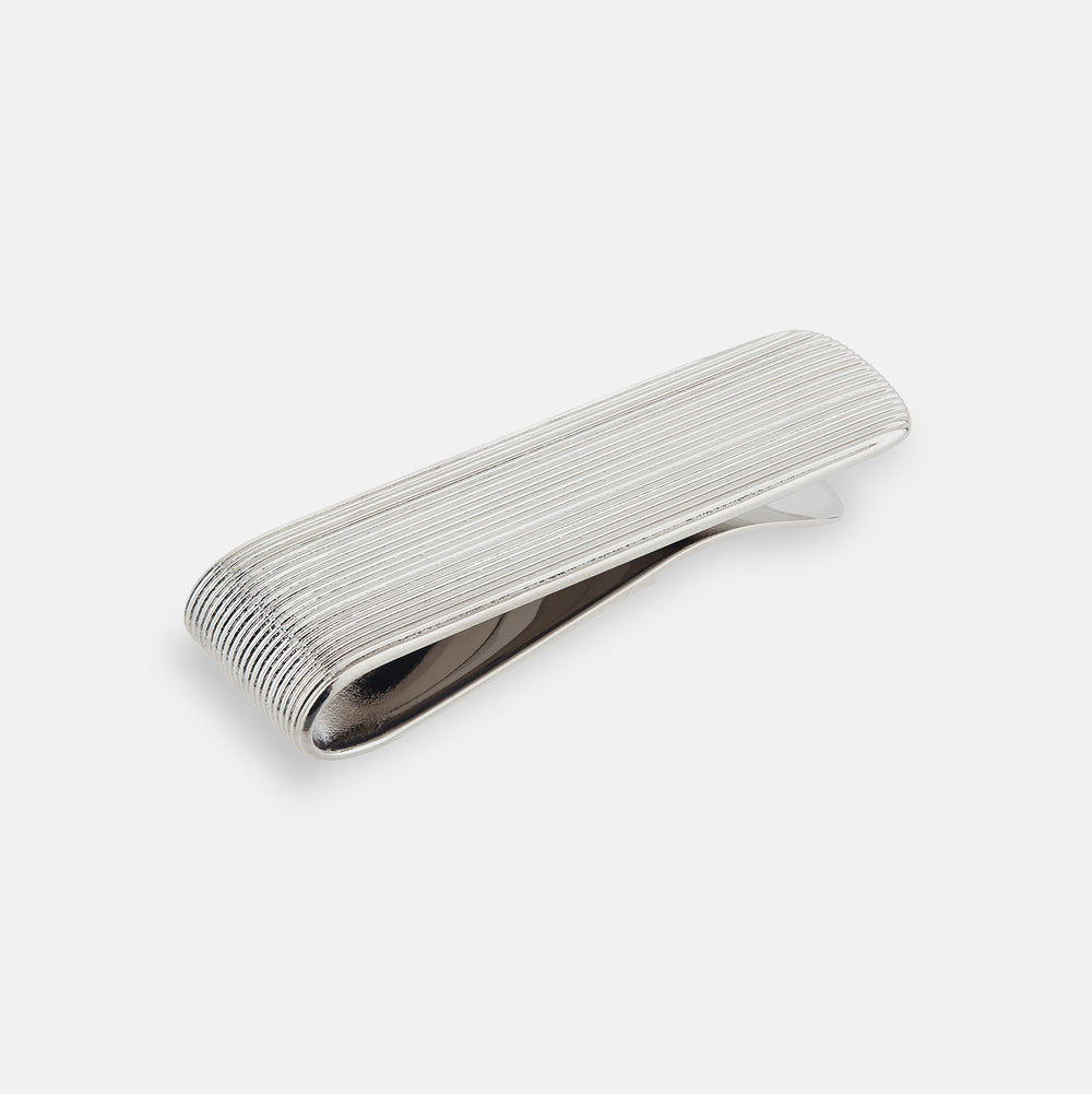 The Turnbull & Asser Silver Striped Money Clip features a ribbed, striped pattern and is displayed against a plain white background.