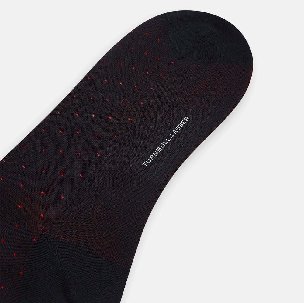 A single Turnbull & Asser Navy/Red Polka Dot Long Sock, crafted from mercerised Egyptian cotton, is displayed against a plain white background.