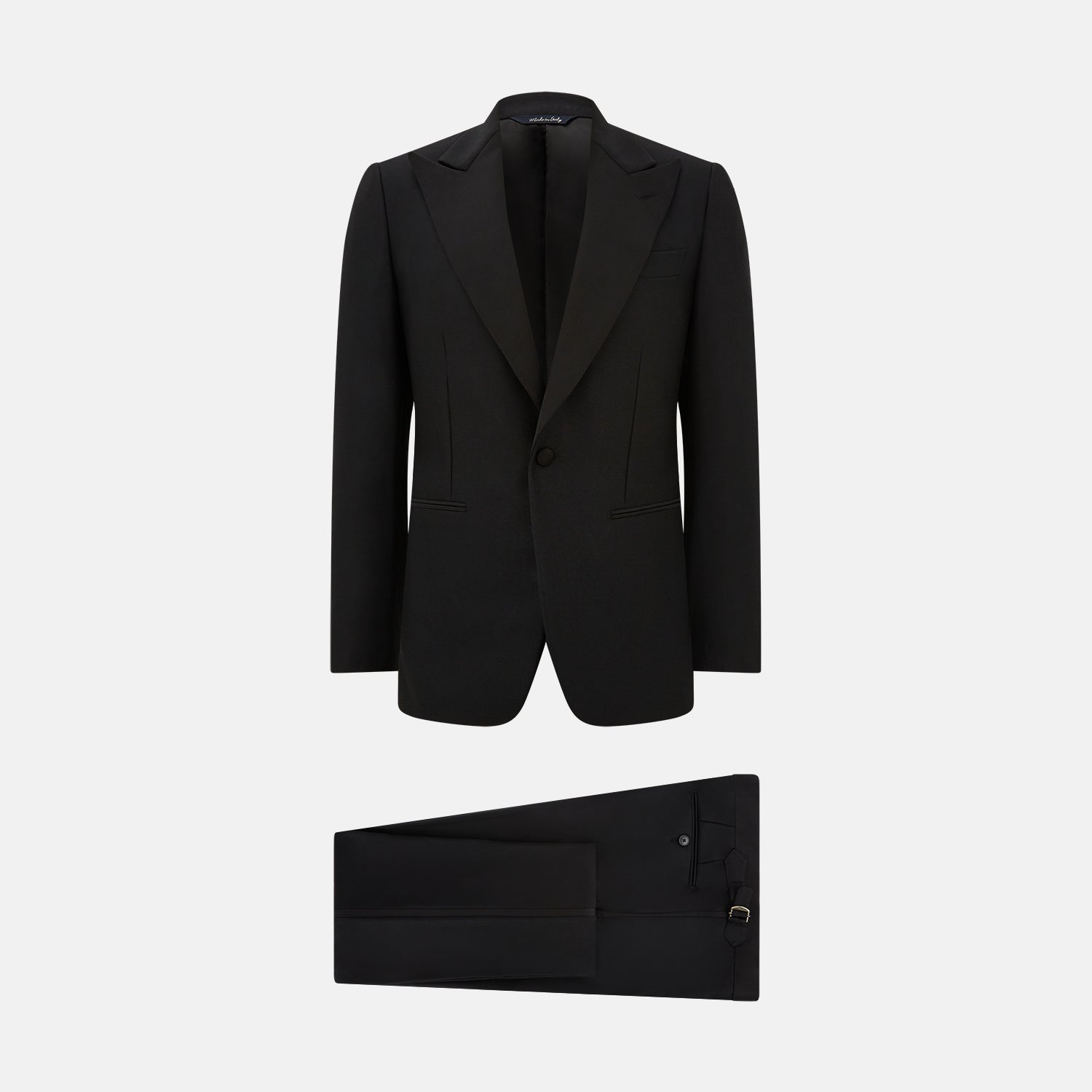 View 1 of product The Turnbull & Asser Black Single Breasted Dinner Suit, with satin lapels and matching trousers, is elegantly folded and displayed on a plain white background.