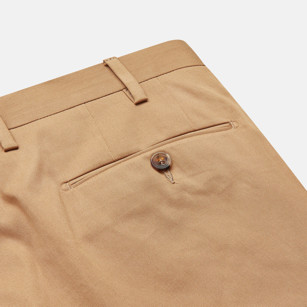 The Camel Front Pleated Manson Trouser by Turnbull & Asser, tailored in Italy with belt loops, front crease, side pockets, and a button closure, is shown laid flat on a white background.