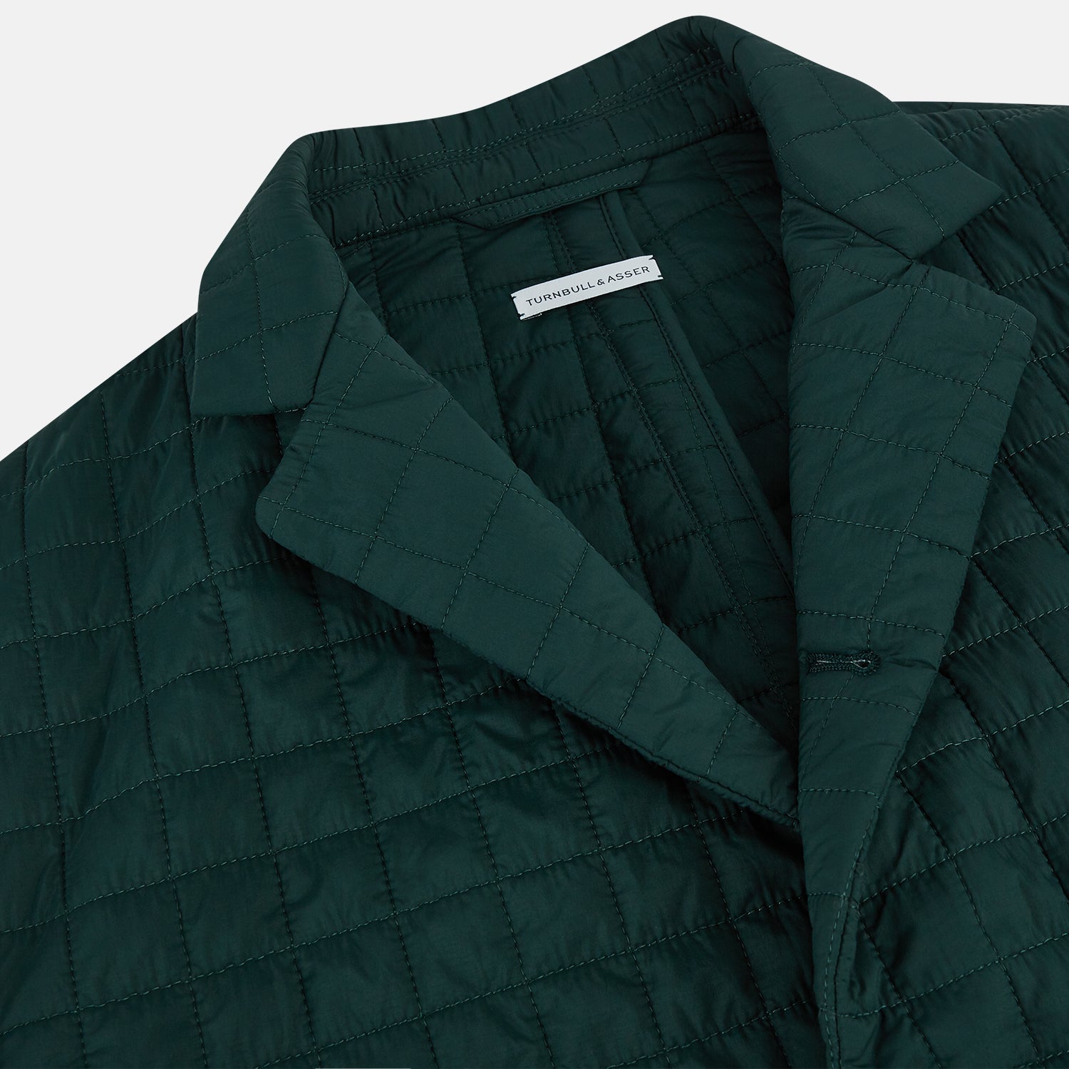View 2 of product The Turnbull & Asser Fulham Forest Green Single-Breasted Quilted Blazer features a three-button front, notched lapels, chest pocket, and two front flap pockets—an elegant choice for the modern gentleman on a plain white background.