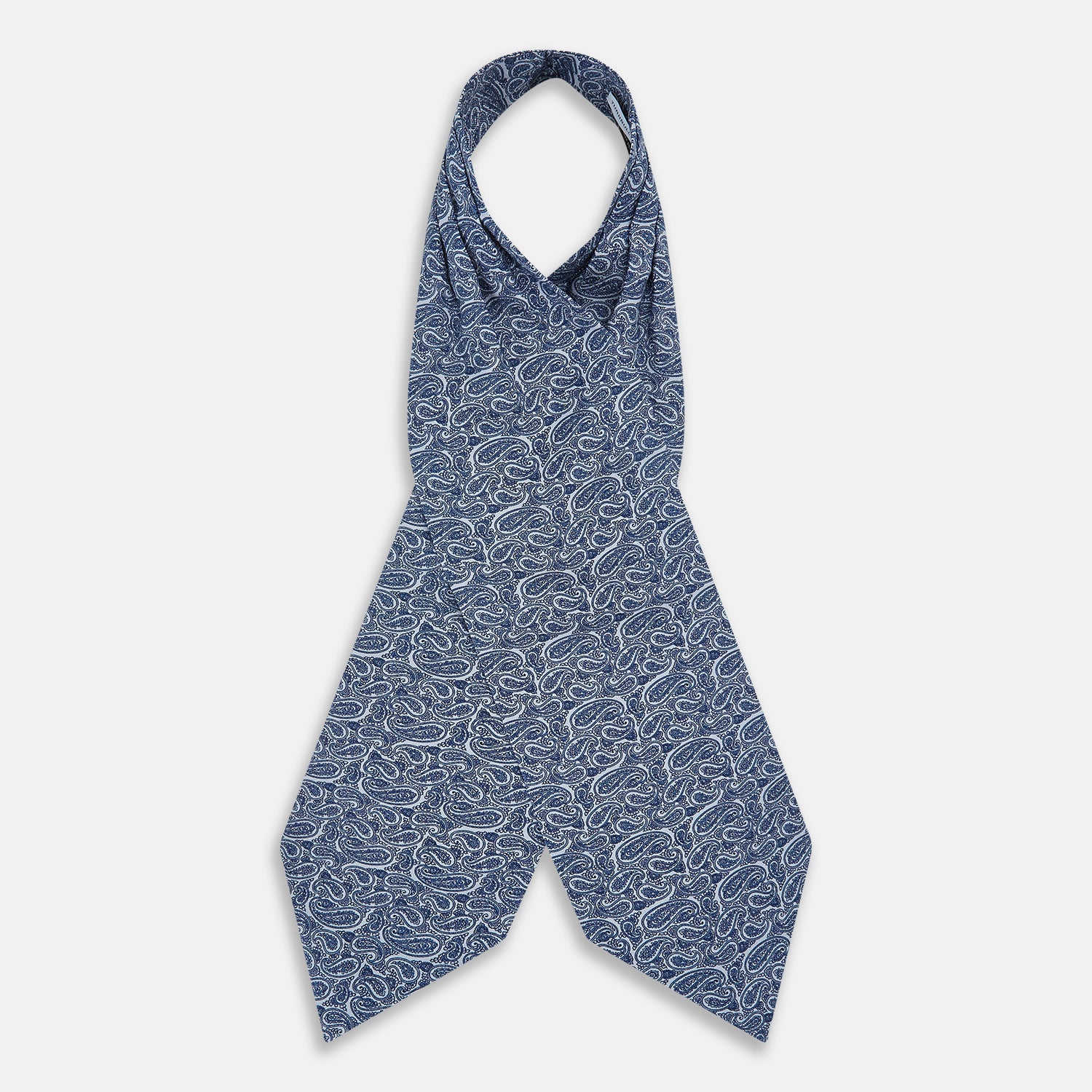 View 2 of product The Pale Blue Paisley Silk Cravat by Turnbull & Asser showcases intricate, swirling blue and white paisley designs on a light background, echoing the elegance of British style accessories.