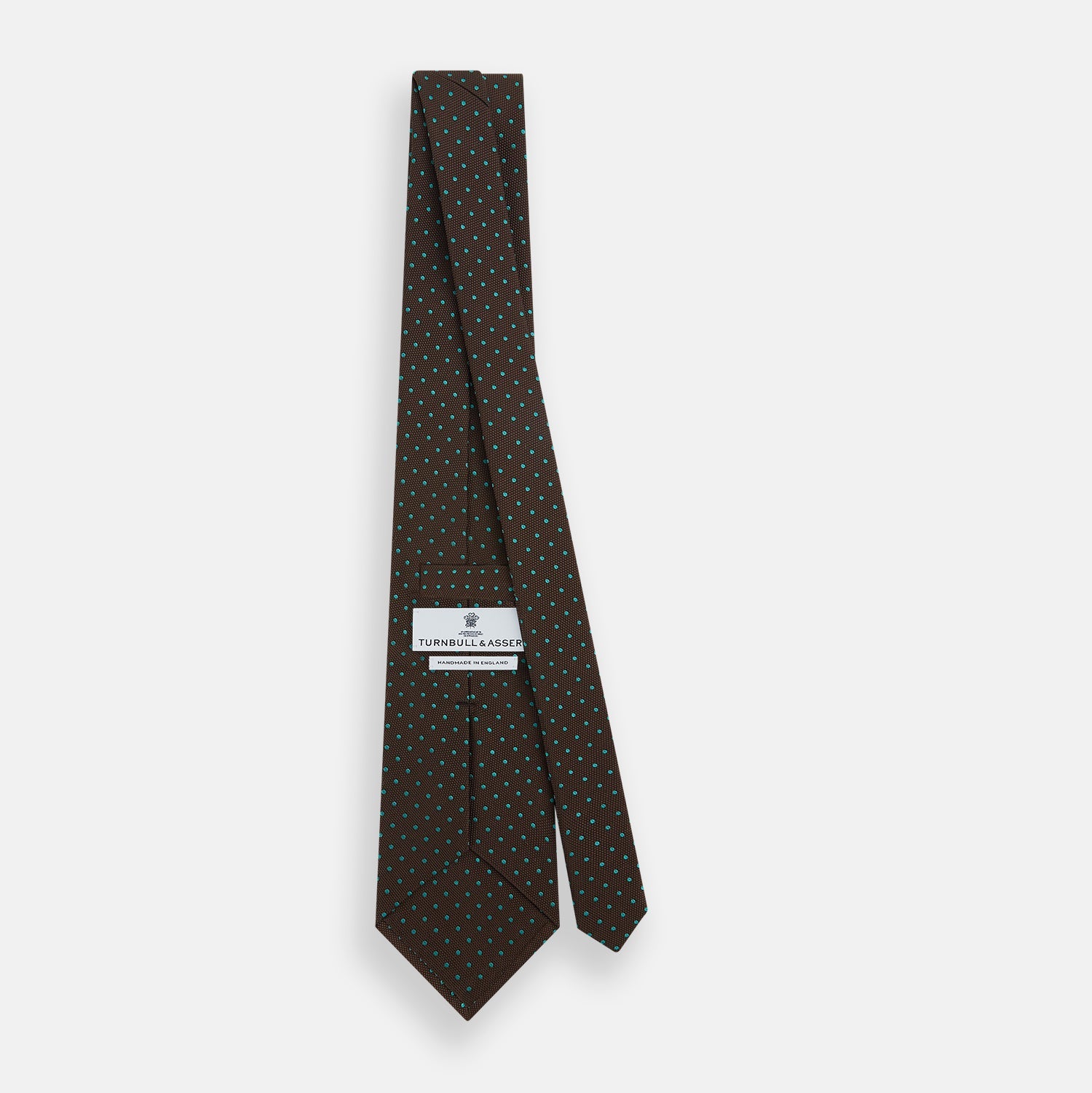 View 4 of product The Turnbull & Asser Green and Brown Micro Dot Silk Tie is shown rolled up, displaying its evenly spaced micro dot pattern against a plain white background.
