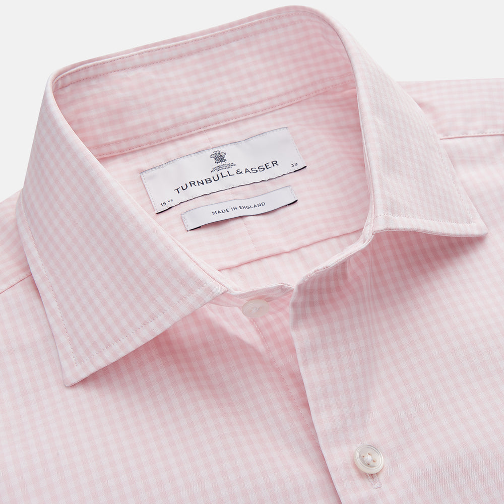The Turnbull & Asser Pink Windowpane Check Shirt features long sleeves, a button-down front, pointed collar, and buttoned cuffs—an elegant addition to any formal shirt collection.
