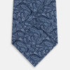 View 3 of product A rolled-up Turnbull & Asser Dark Navy Paisley Printed Silk Tie is shown on a plain light background.