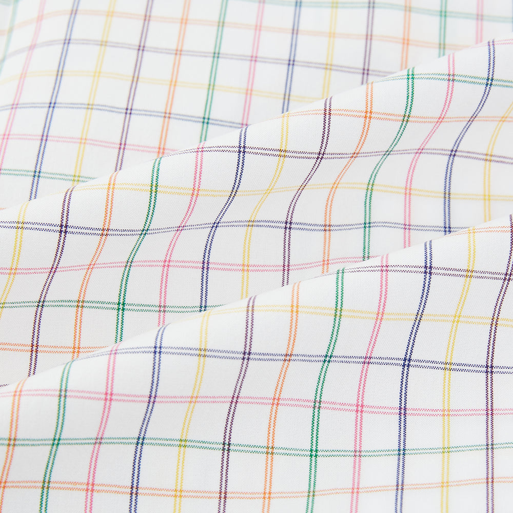The Rainbow Double Grid Check Mayfair Shirt by Turnbull & Asser features a white base with thin blue, red, and green checks and a T&A collar. It’s displayed neatly laid flat on a white background.