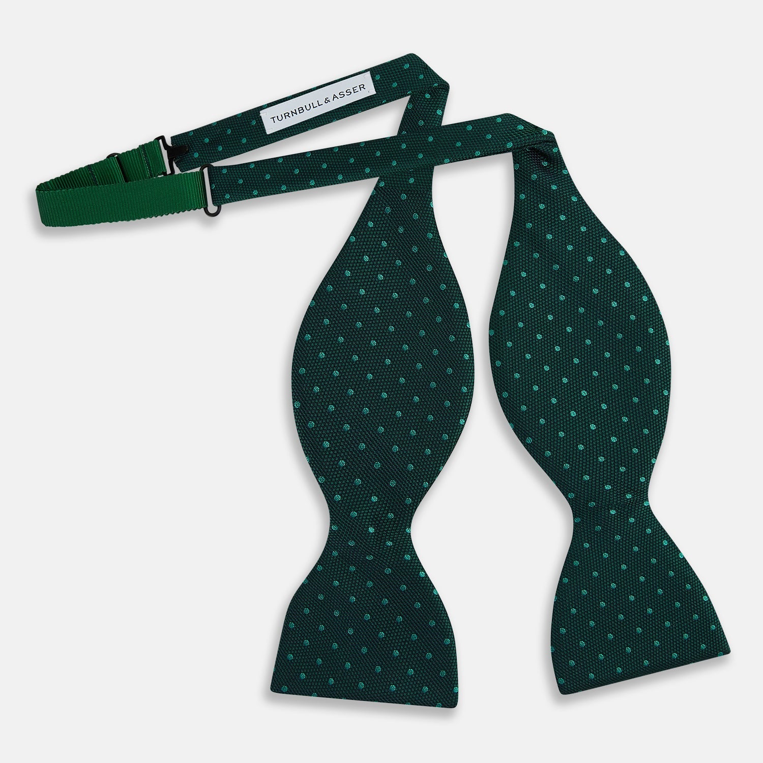 View 6 of product The Turnbull & Asser Dark Green and Navy Micro Dot Silk Bow Tie, featuring a refined dotted pattern, is showcased on a plain white background—an elegant accessory perfect for any occasion.