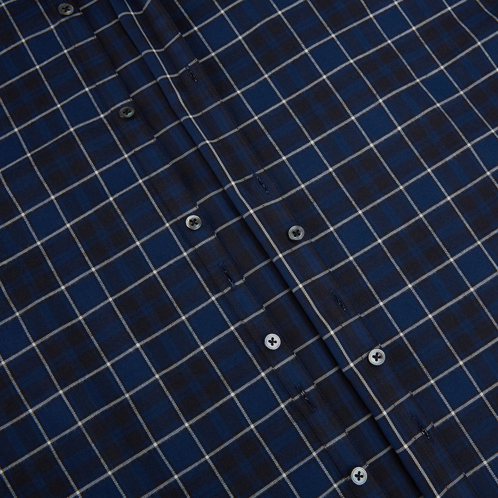 The Turnbull & Asser Navy and White Check Windsor Shirt features a long-sleeve design with a navy base and white check pattern, showcasing British craftsmanship and displayed on a white background.