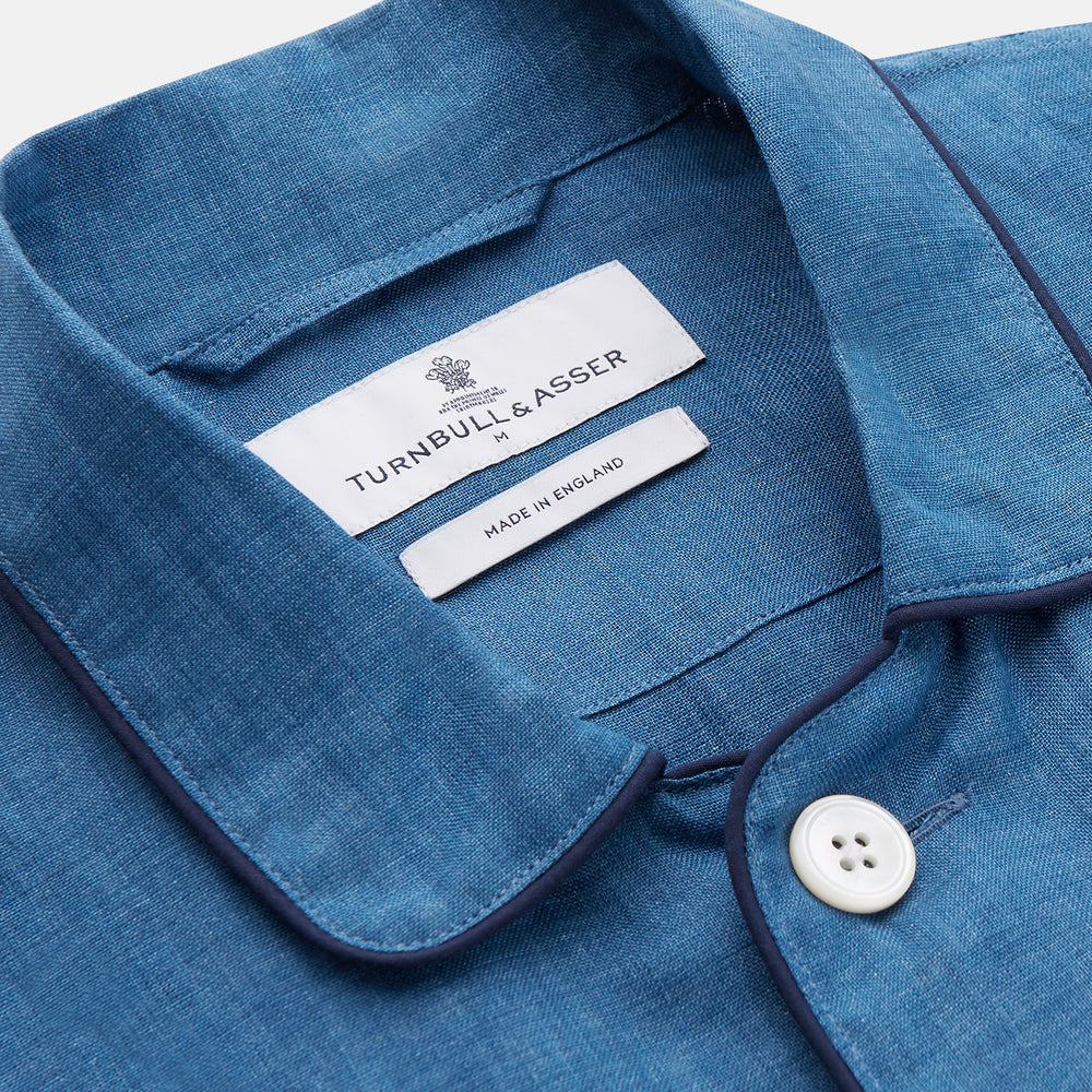 A person stands barefoot against a plain background, wearing the Teal Linen Modern Pyjama Set from Turnbull & Asser.