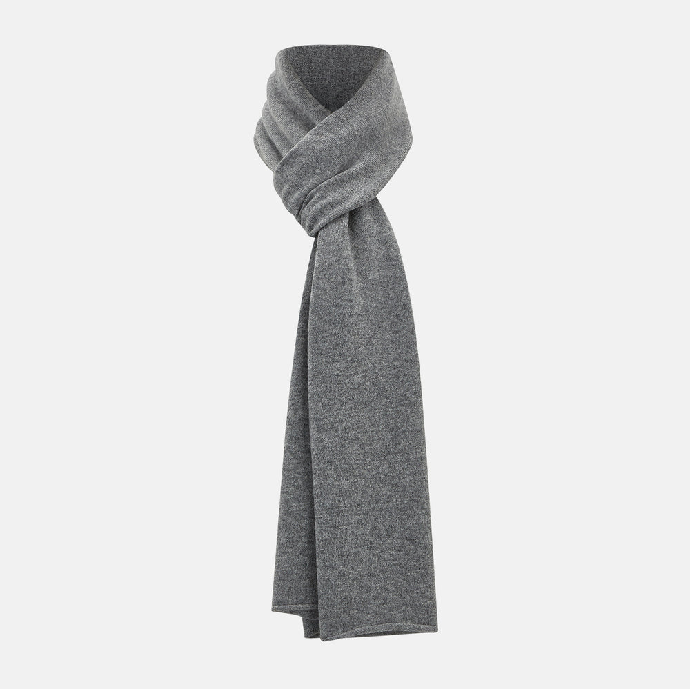 The Turnbull & Asser Plain Grey Cashmere Knitted Scarf is shown draped against a white background, highlighting its soft luxury and timeless appeal.