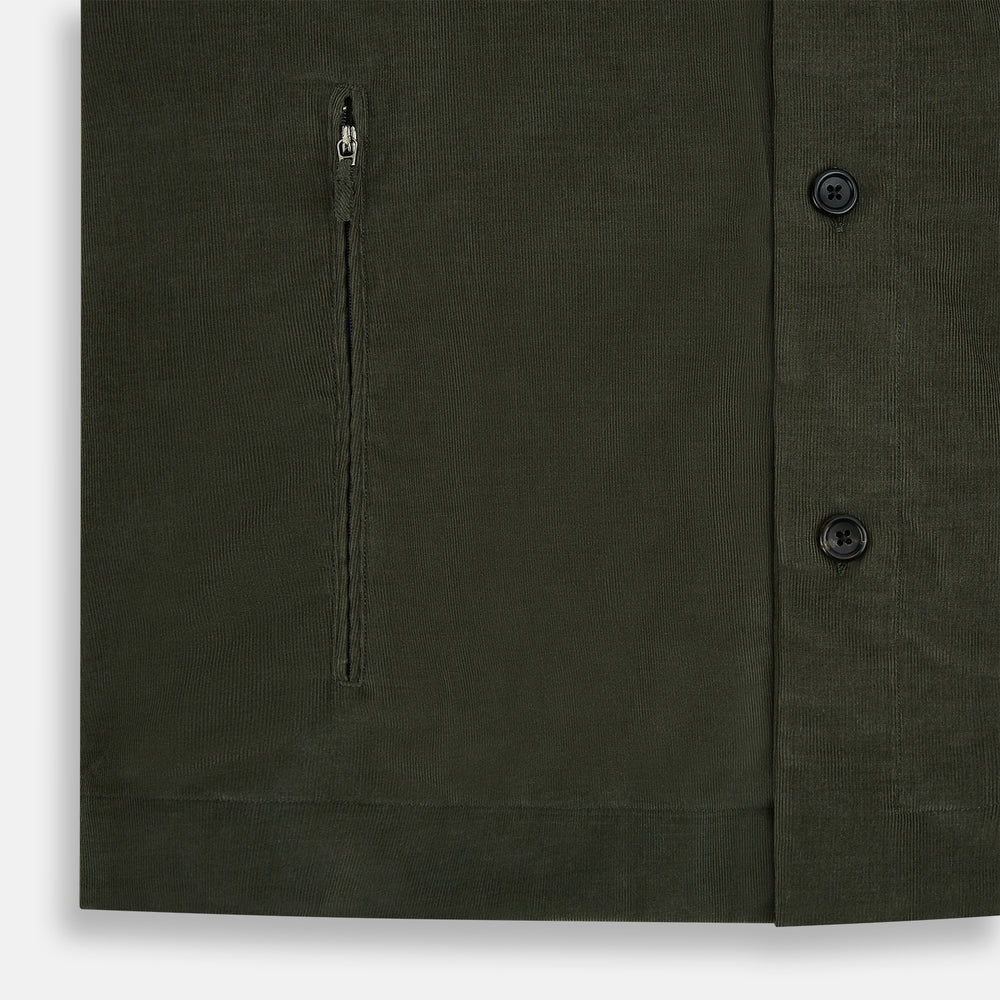 The Turnbull & Asser Olive Corduroy Hampstead Overshirt for men features a collar, long sleeves, left chest pocket, and two zippered side pockets, shown laid flat on a white background.