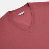 View 2 of product The Turnbull & Asser Antique Pink Merino V-Neck Jumper features ribbed cuffs, hem, and neckline in a soft antique pink, shown on a plain white background. Part of our knitwear collection.