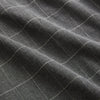 View 6 of product The Turnbull & Asser Charcoal Melange Check Hampstead overshirt, a long-sleeve button-up with a collar and two zippered side pockets, is laid flat on a light gray background.