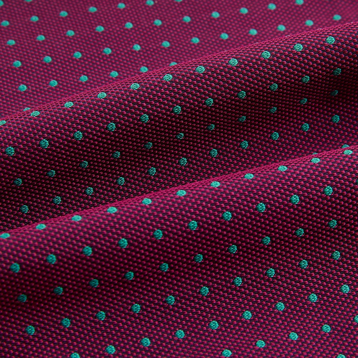 Image 4 of product A burgundy pocket square with turquoise polka dots, folded to a point—an ideal men's formal accessory to complement the Green Micro Dot and Magenta Silk Cravat by Turnbull & Asser.