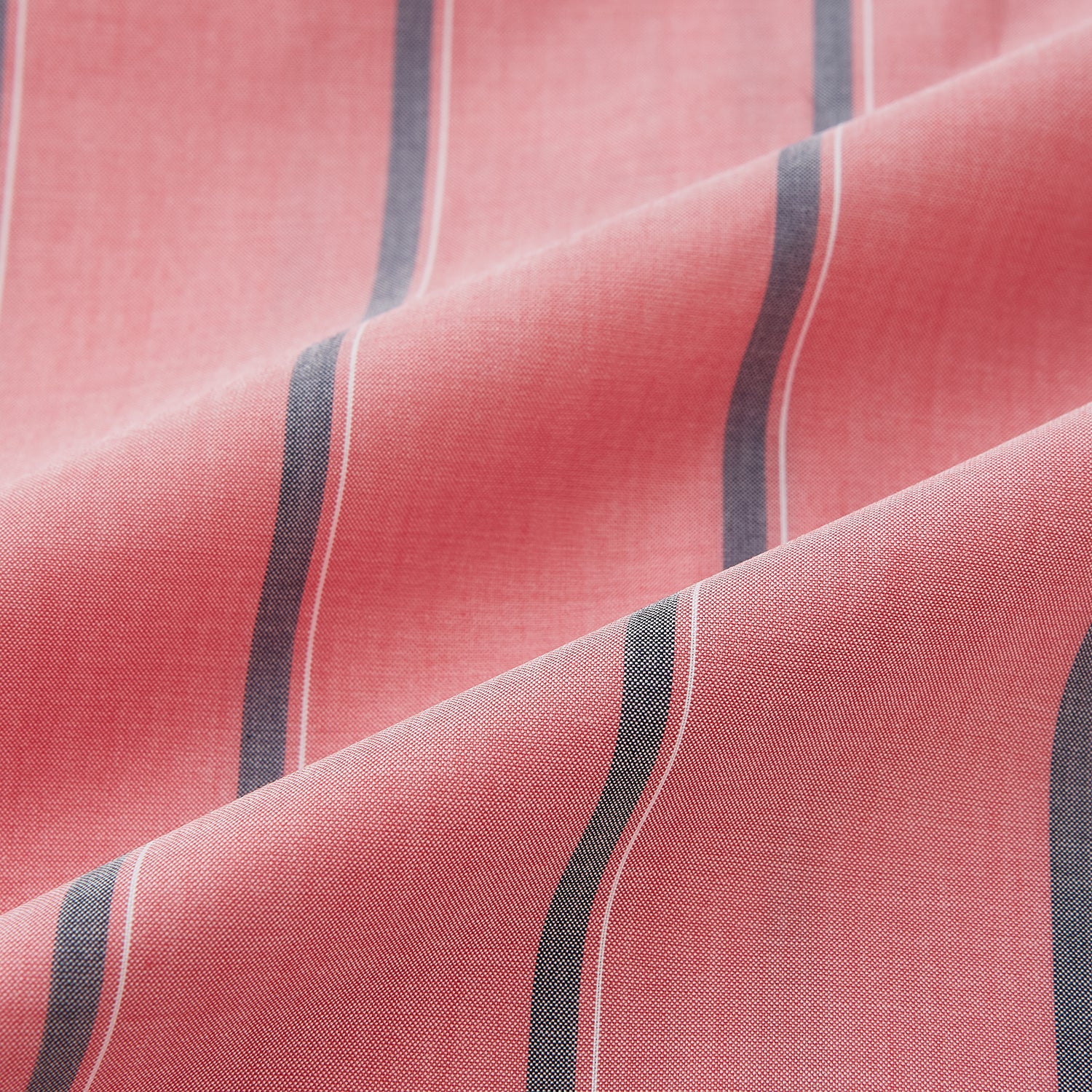 Image 8 of product The Coral Pink Track Stripe Westminster Shirt by Turnbull & Asser features vertical navy and white stripes, a tailored fit, pointed collar, and buttoned cuffs—is displayed laid flat on a white background.