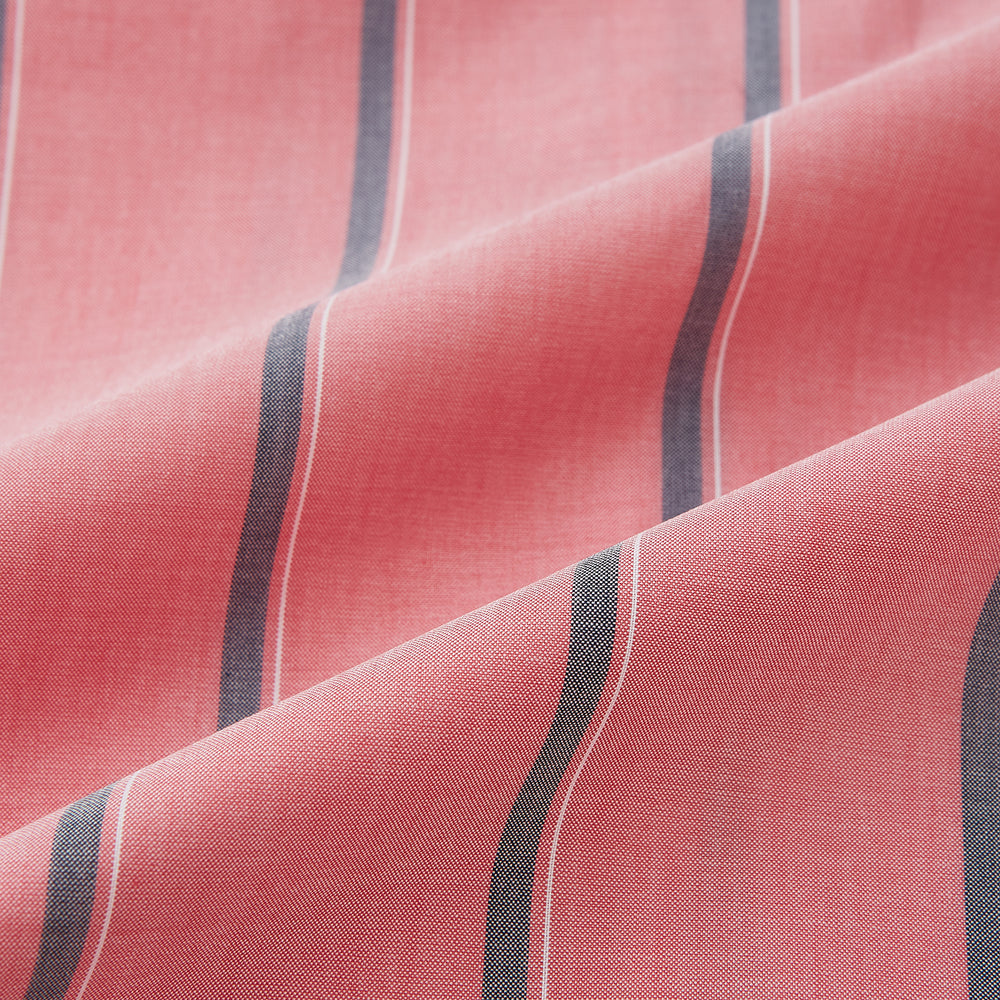 The Coral Pink Track Stripe Westminster Shirt by Turnbull & Asser features vertical navy and white stripes, a tailored fit, pointed collar, and buttoned cuffs—is displayed laid flat on a white background.