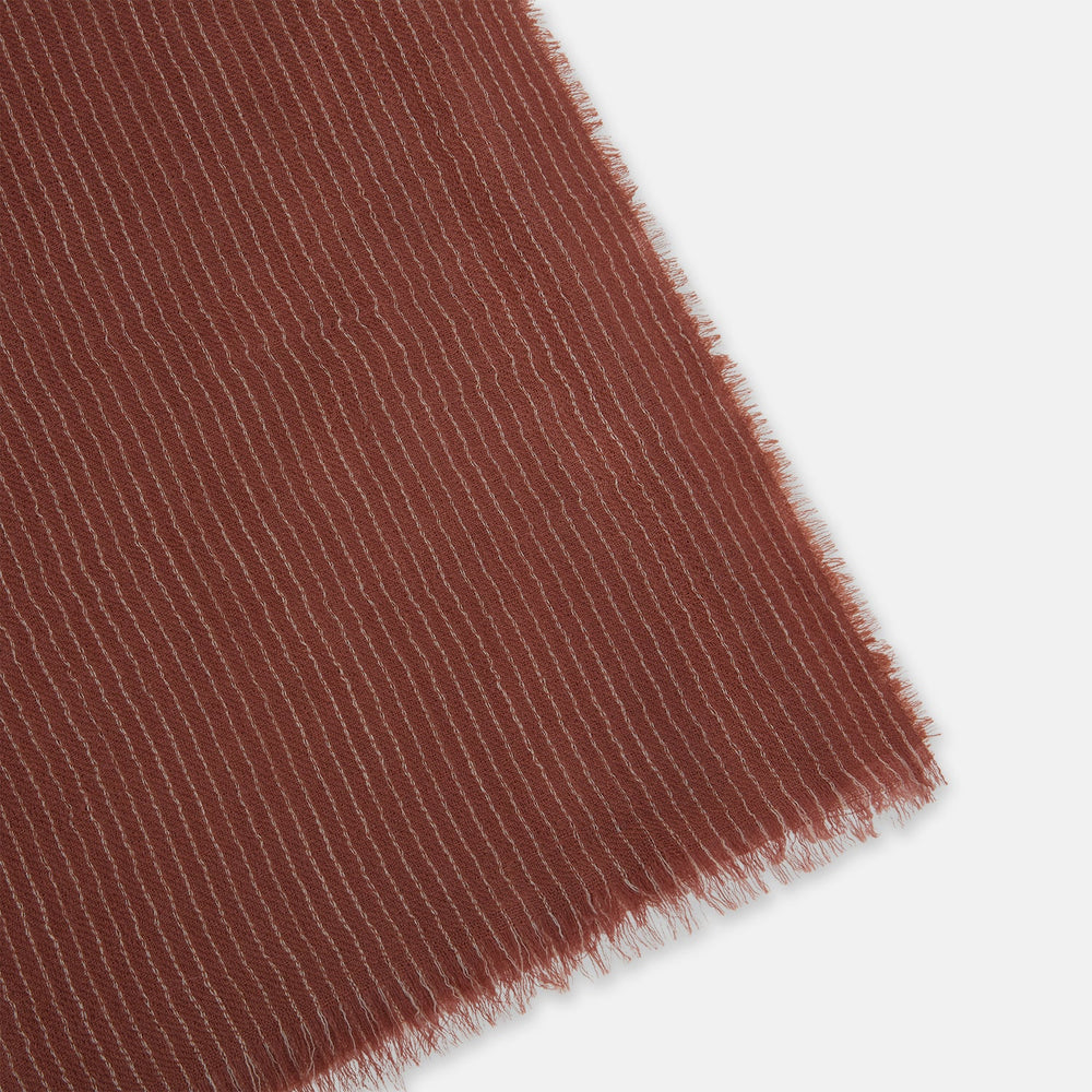 A Burgundy and White Striped Cashmere Scarf by Turnbull & Asser is neatly folded on a plain, light gray background.